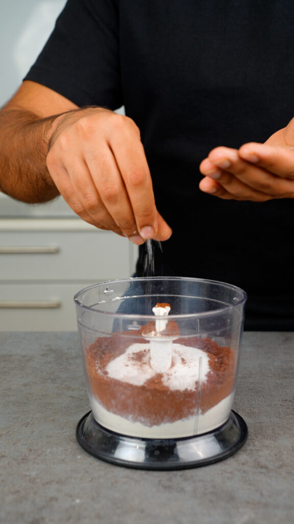 mixing flour, cocoa powder, sugar, and salt in a food processor