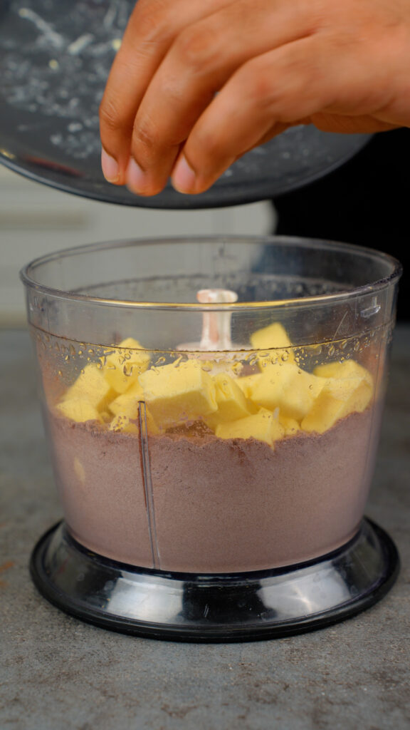 adding cold cubes of butter to food processor