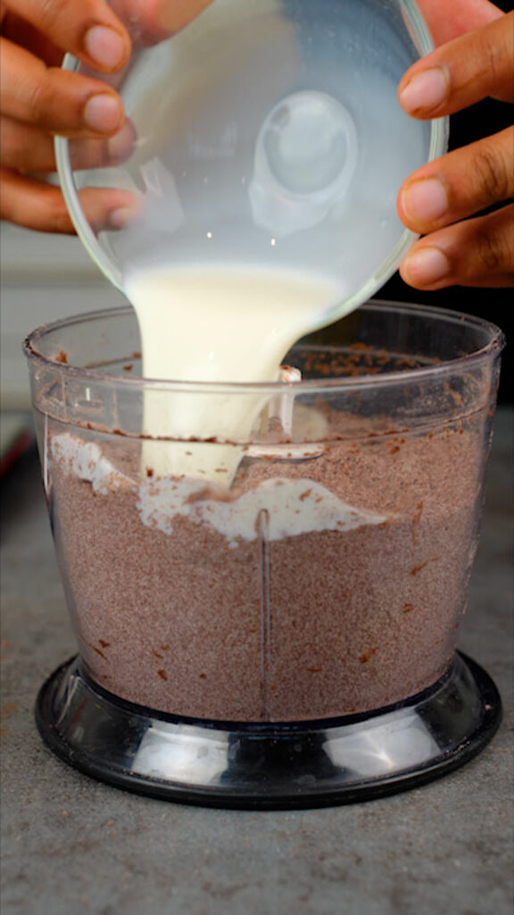 pouring milk into food processor