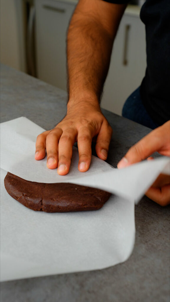 wrapping chocolate pastry dough in baking paper