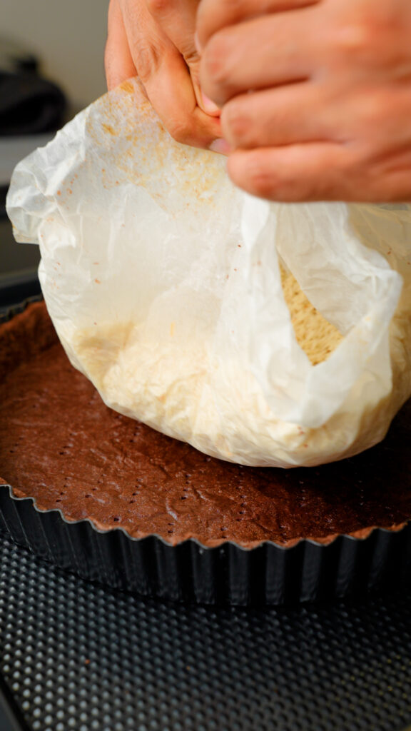 removing rice and finishing bling bake of chocolate shortcrust pastry