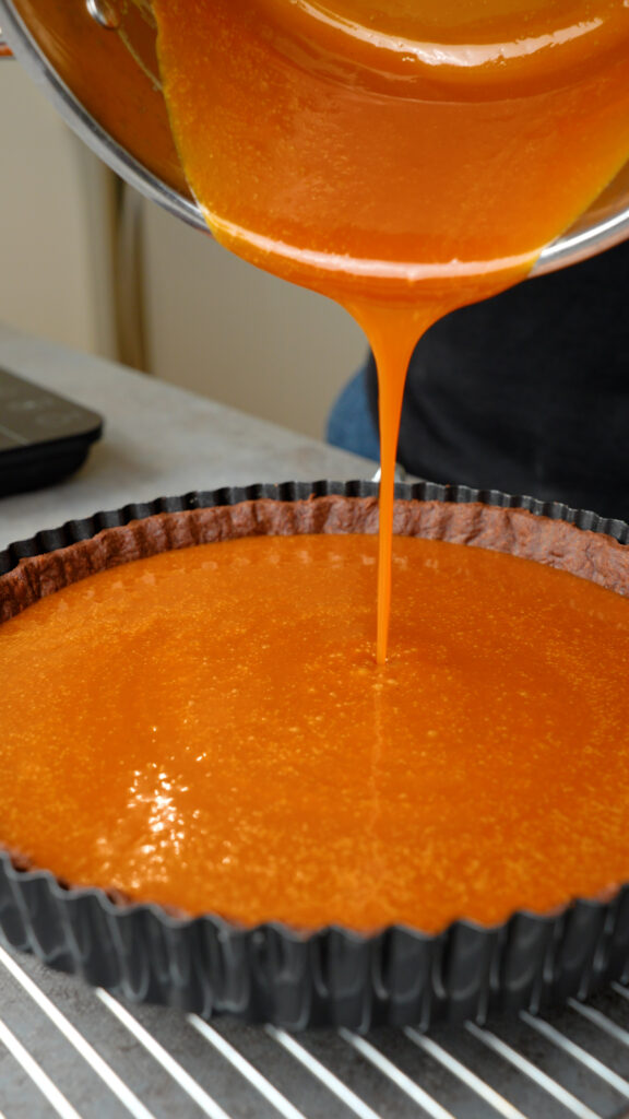 pour caramel sauce into the chocolate shortcrust pastry