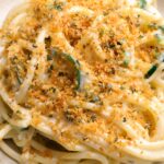 jalapeno popper bucatini in a plate with breadcrumbs on top