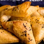 Flaky Potato and Brie Parcels stacked together on a wire rack