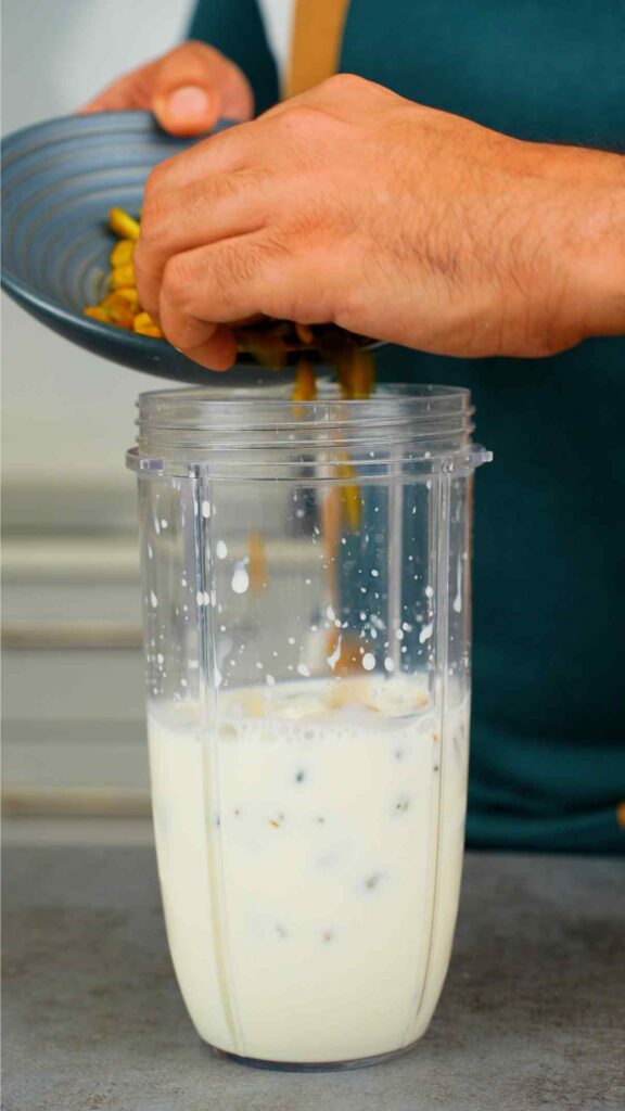 pouring pistachios into milk