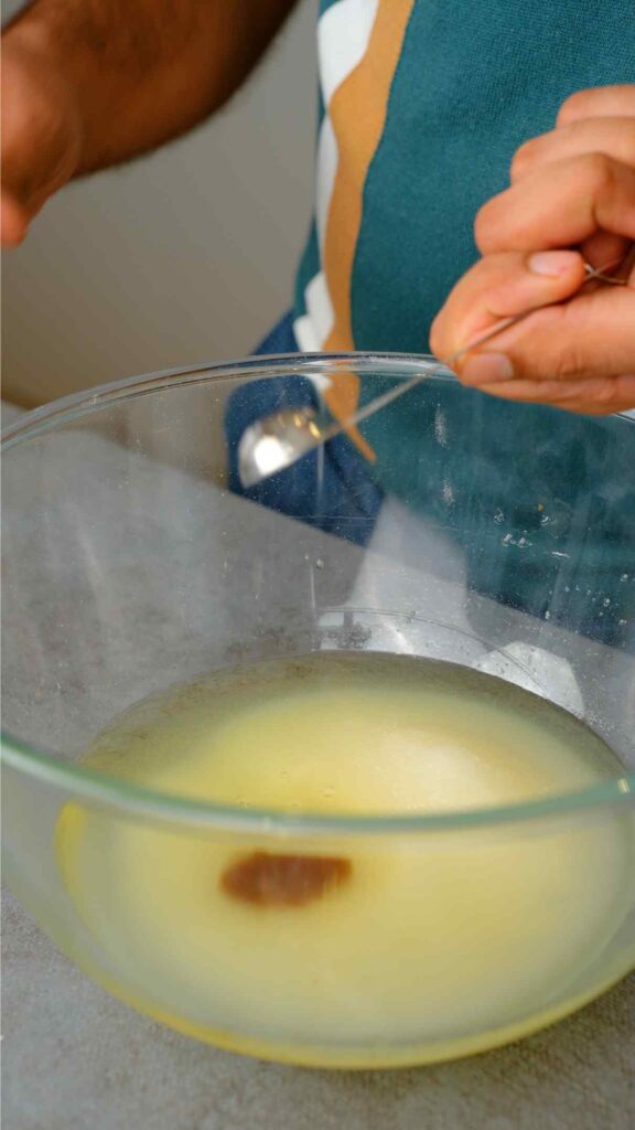 oil sugar, cardamom, almond extract, and vanilla in a mixing bowl