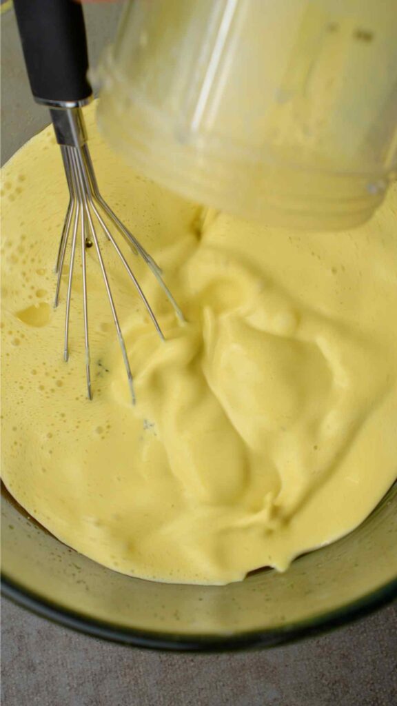 adding pistachio milk to the mixing bowl