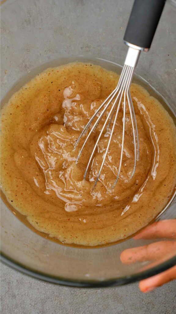 whisking oil and sugar mixture together