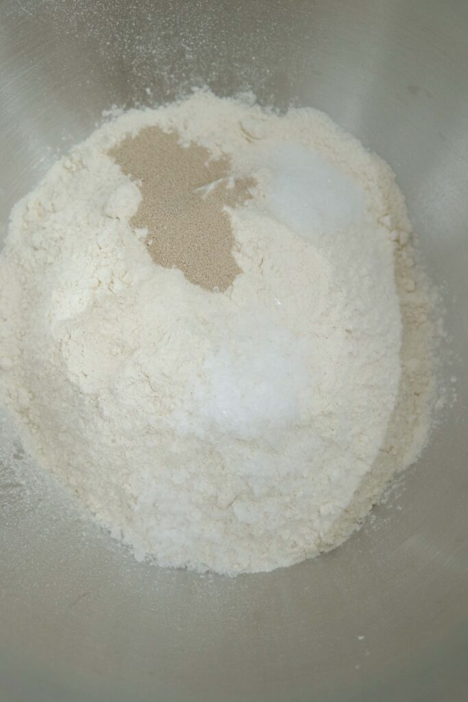 flour, sugar, salt and instant yeast, these are the dry ingredients for chilli garlic naan dough