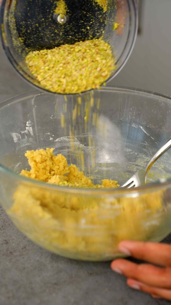 add some of the ground pistachios and almonds to the dough