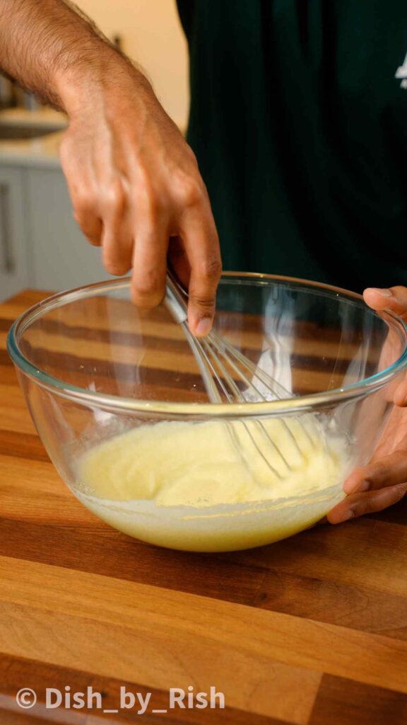 whisking oil, butter, and sugar in a bowl