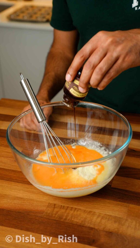 vanilla being poured into mixing bowl