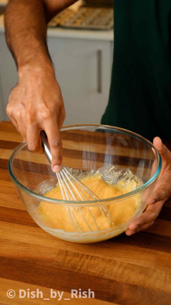 whisking wet mix in a mixing bowl