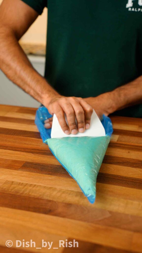 pouring doughnut batter into a piping bag
