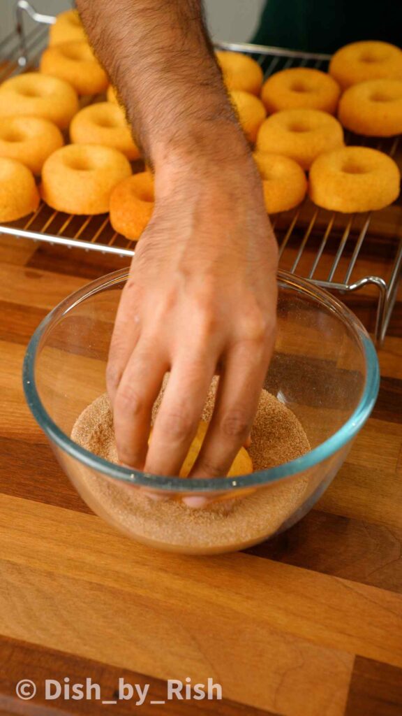 dunking doughnuts in cinnamon sugar
