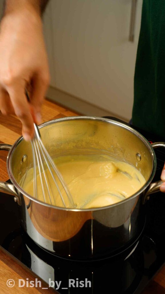 whisking evaporated milk and roux