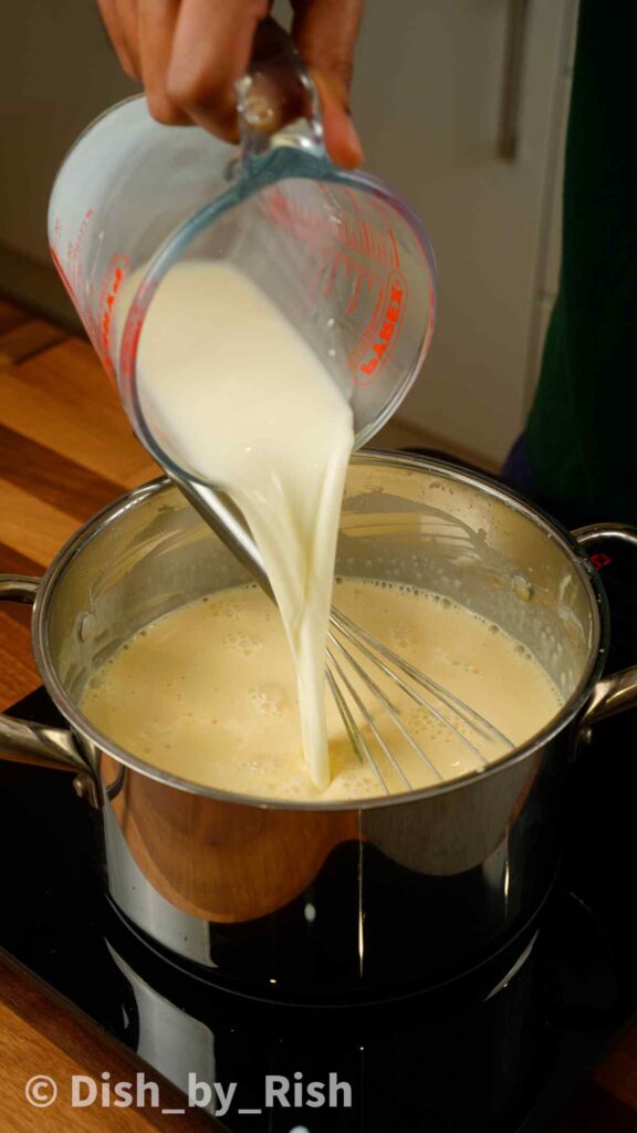 pouring milk into bechamel sauce