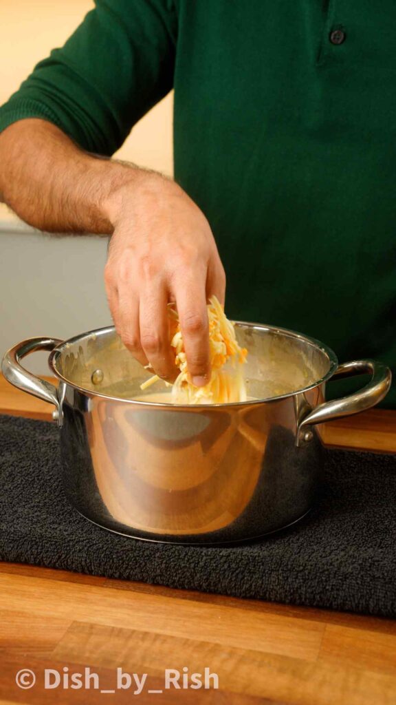 adding cheese mix into bechamel sauce