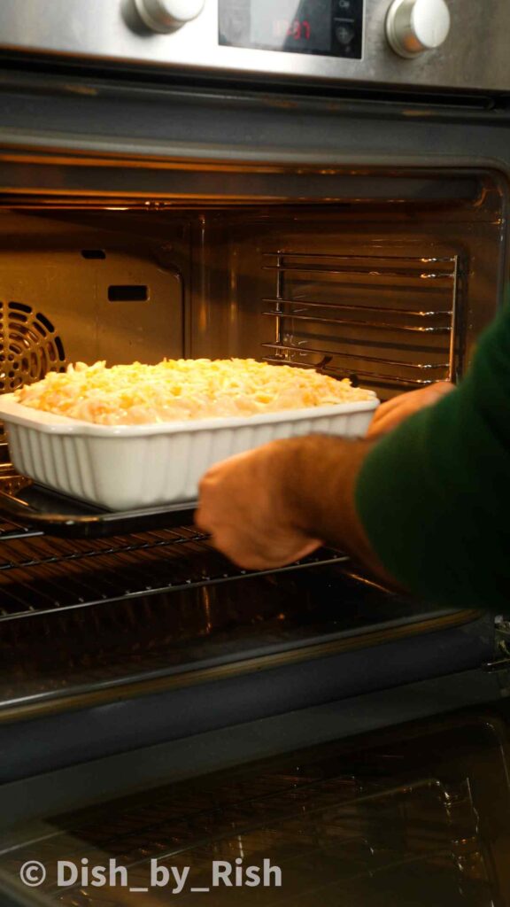 placing mac and cheese int the oven with a tray underneath