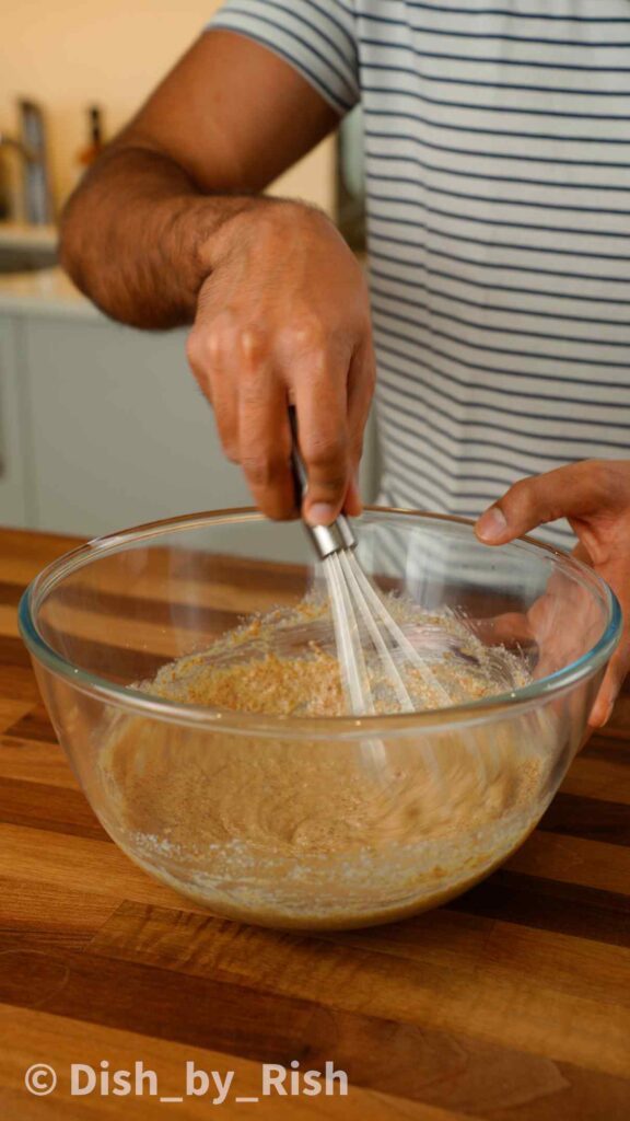 whisking oil, butter, and sugars in a mixing bowl