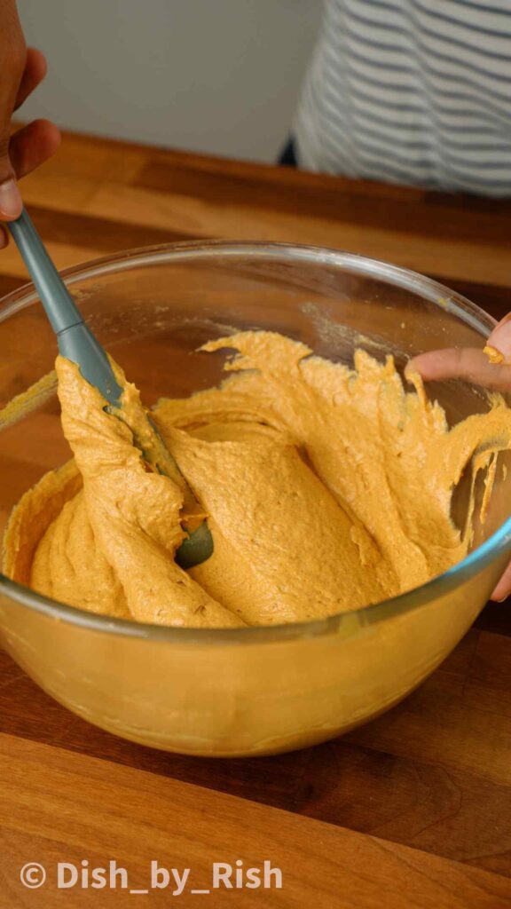 pumpkin spice doughnut batter in a mixing bowk