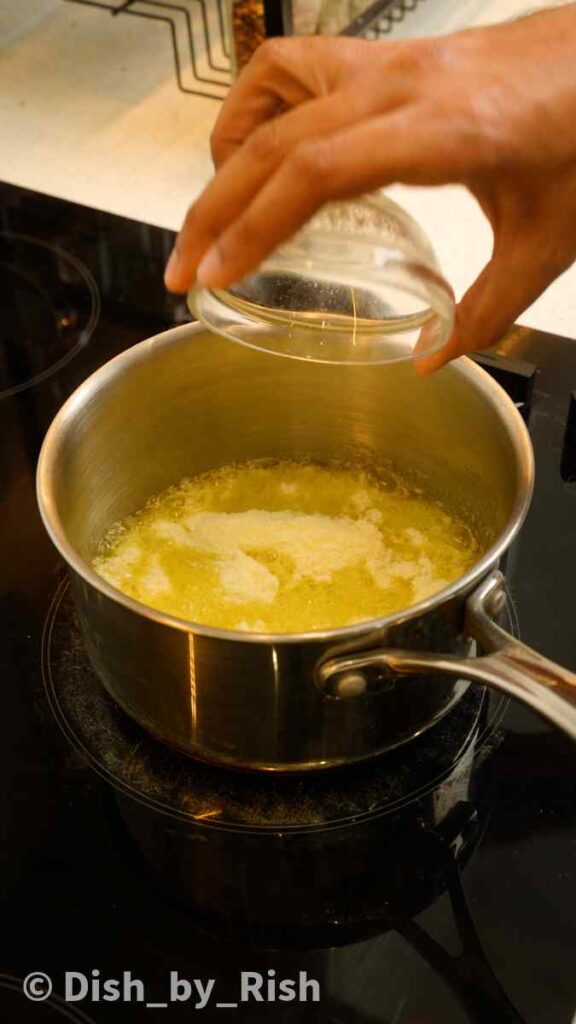 adding milk powder to melted butter in a pan