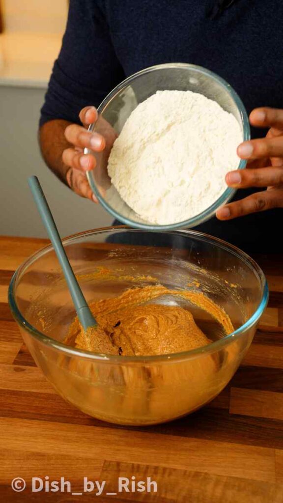 adding dry ingredients to mixing bowl
