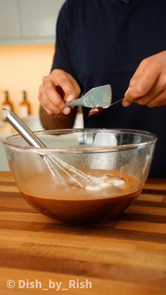 adding red food colouring to wet mix