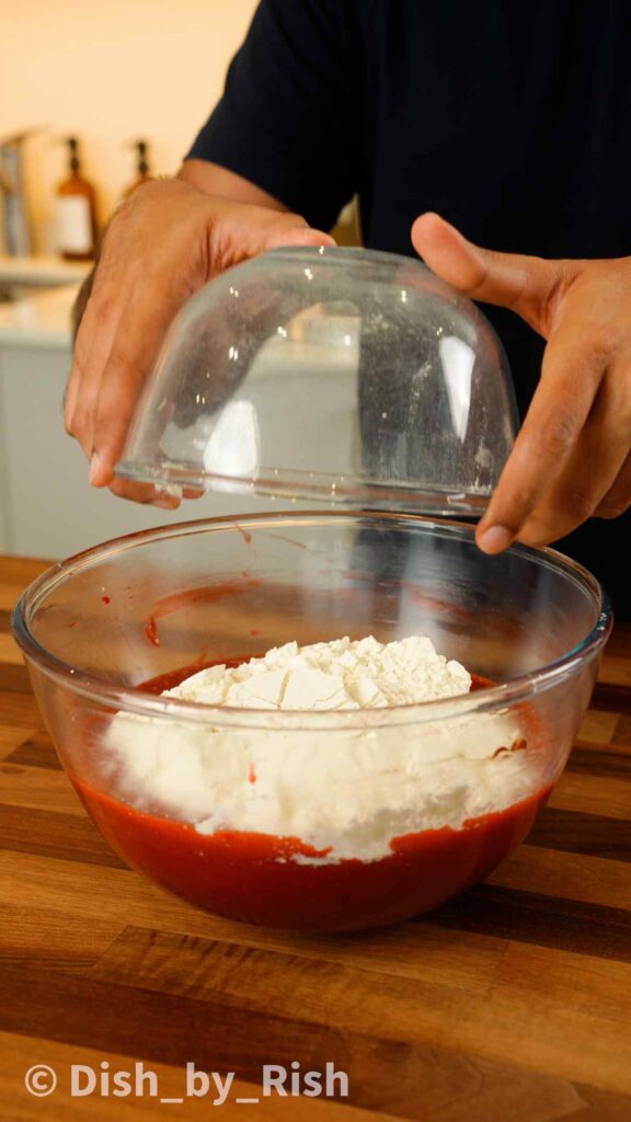adding flour into mixing bowl