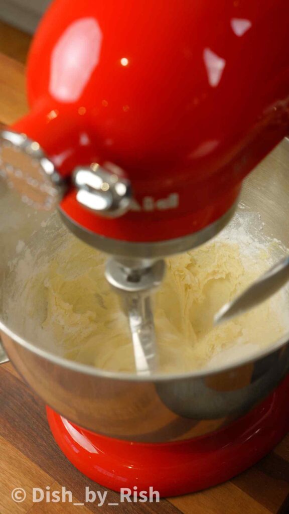 whisking butter and sugar with a paddle attachment in a stand mixer