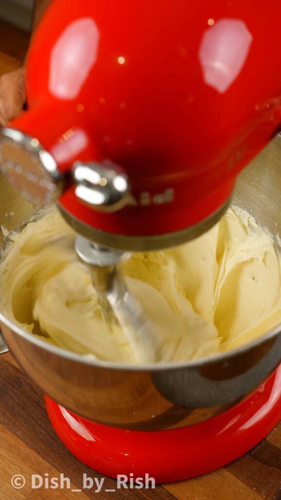 cream cheese frosting in a mixing bowl on a stand mixer