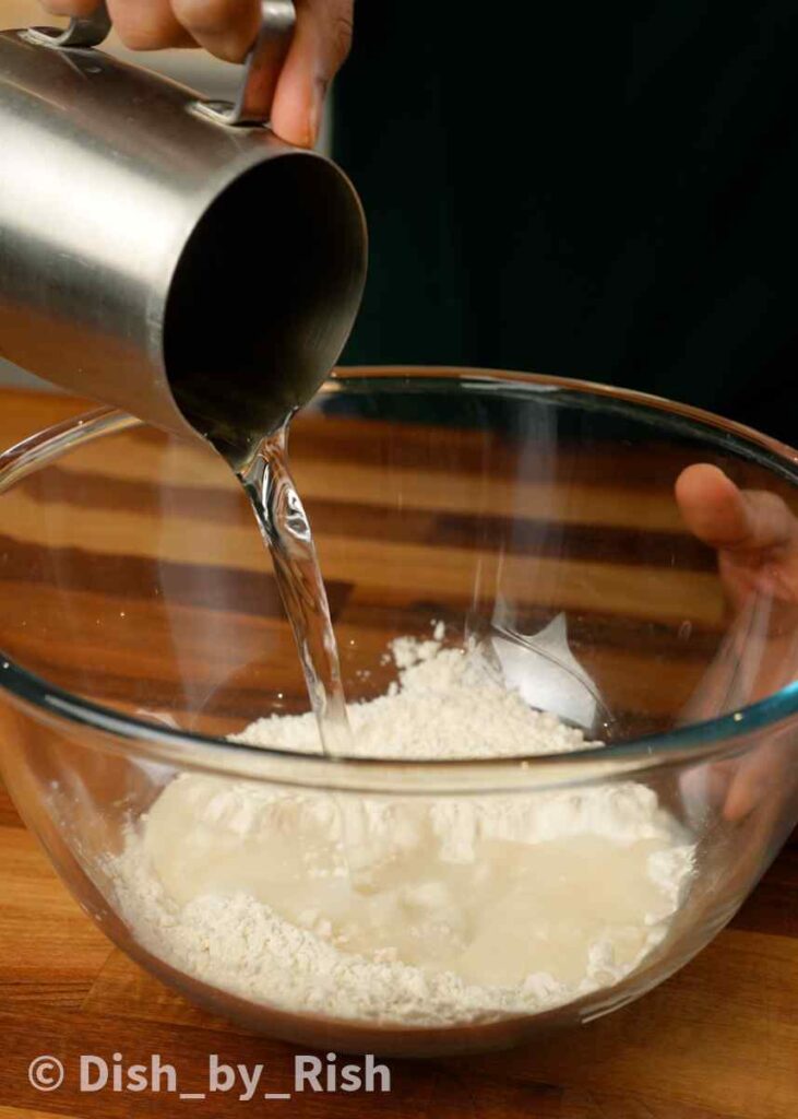 pouring water over flour and yeast