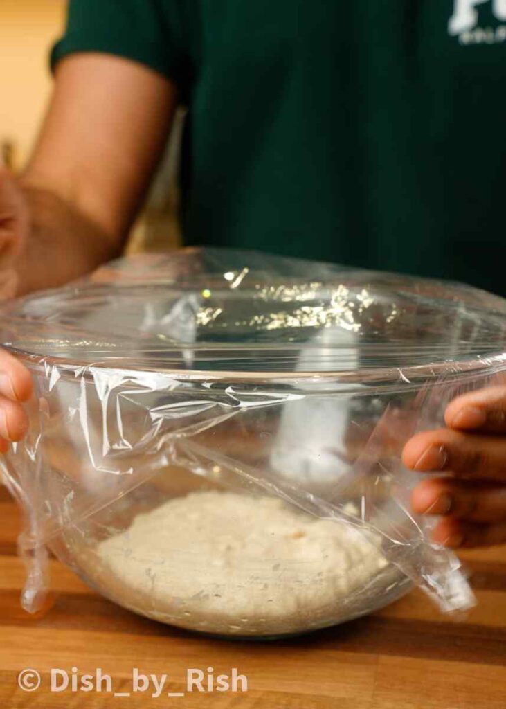 covering poolish in bowl with clingfilm