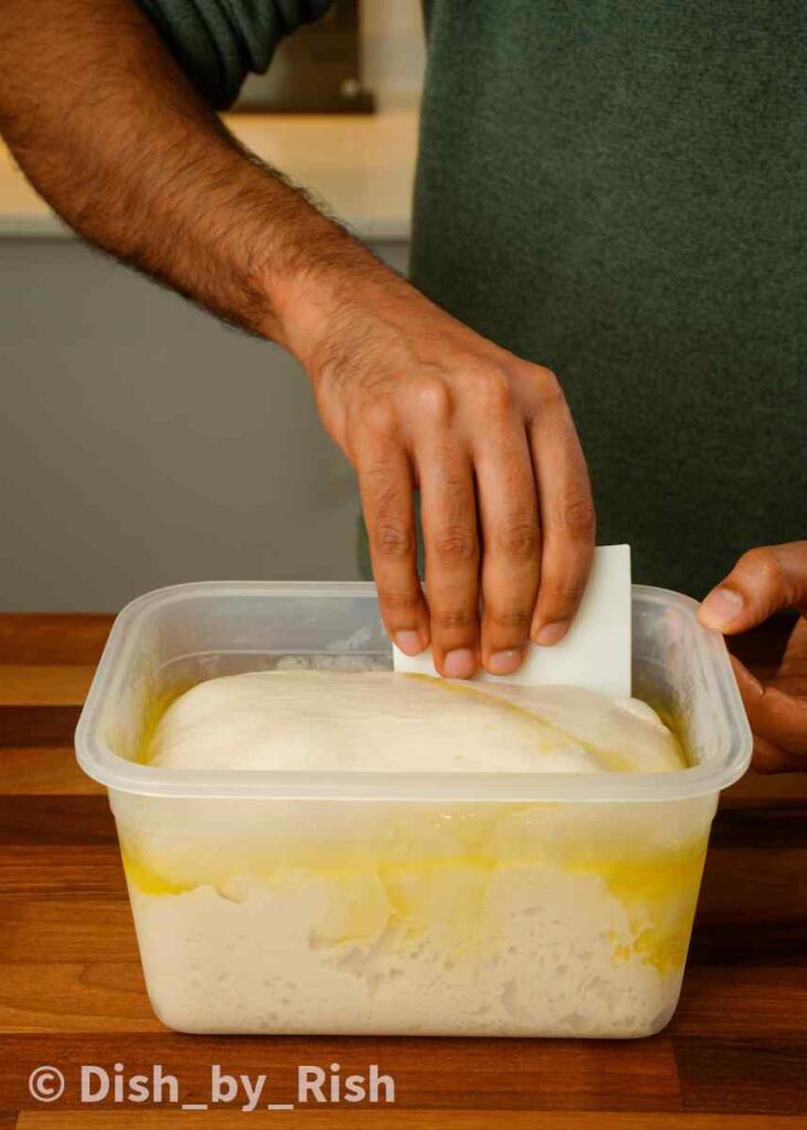 loosening dough from container with dough scraper