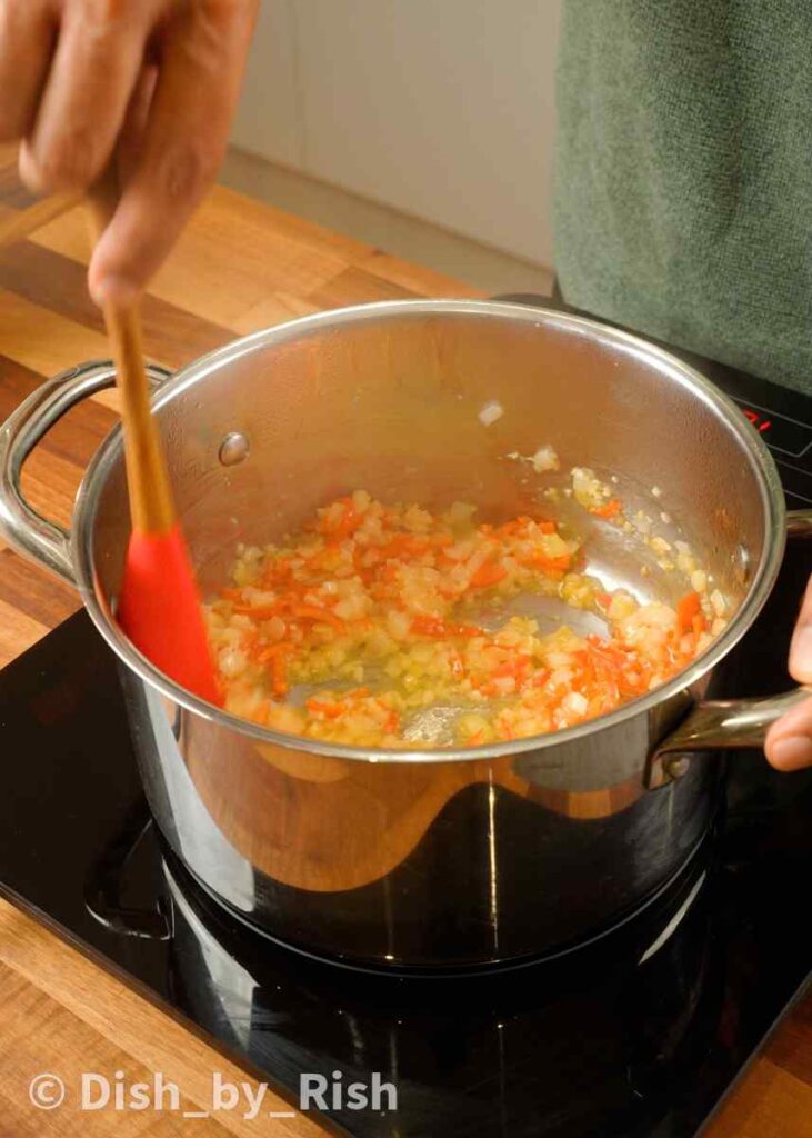 cooking shallots, garlic, and chillies in a pan