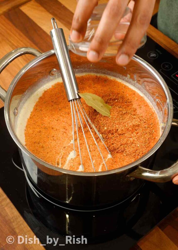 adding spices and bay leaves