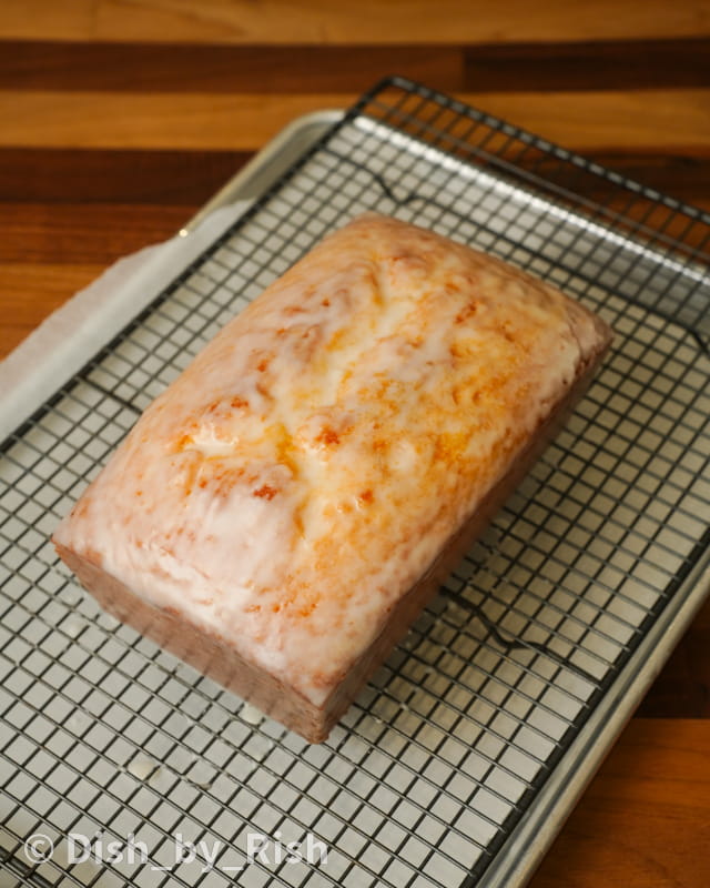 lemon loaf cake with lemon glaze on a wire rack