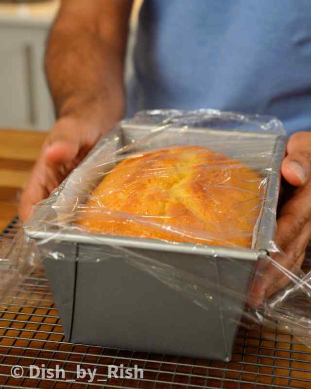 lemon loaf cake being wrapped in clingfilm