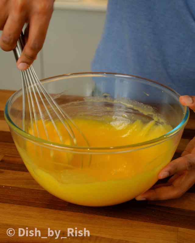 lemon drizzle wet batter being whisked in a mixing bowl