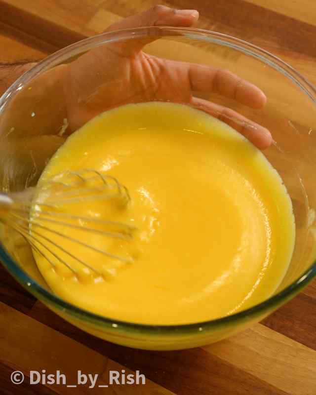 lemon drizzle wet batter being whisked in a mixing bowl