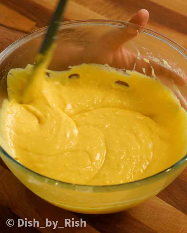 lemon drizzle cake batter being folded with a spatula