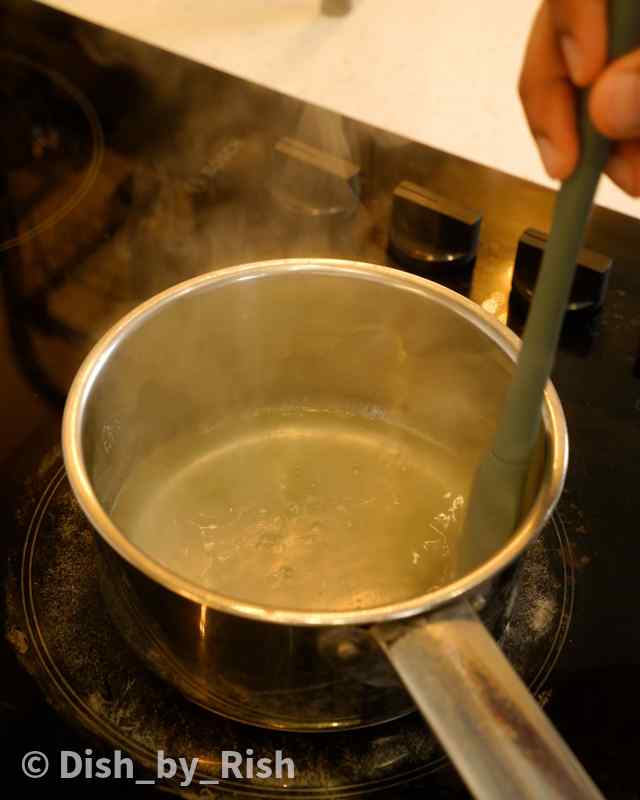 lemon soaking syrup simmering in a saucepan