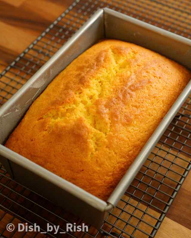 baked lemon loaf cake cooling on a wire rack